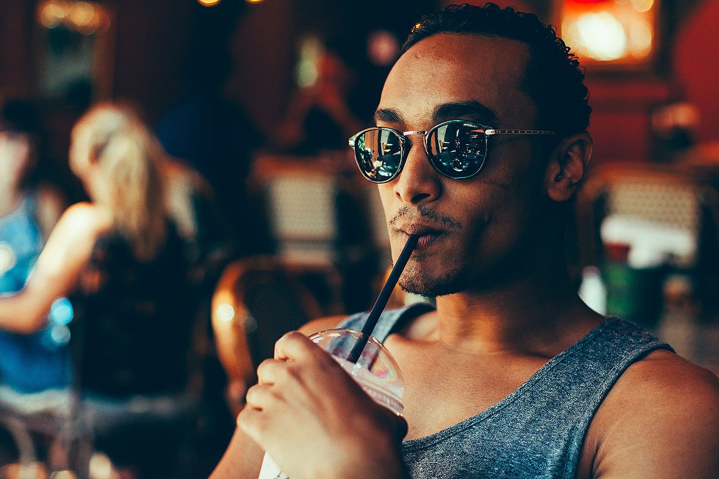 A man drinking a smoothie.